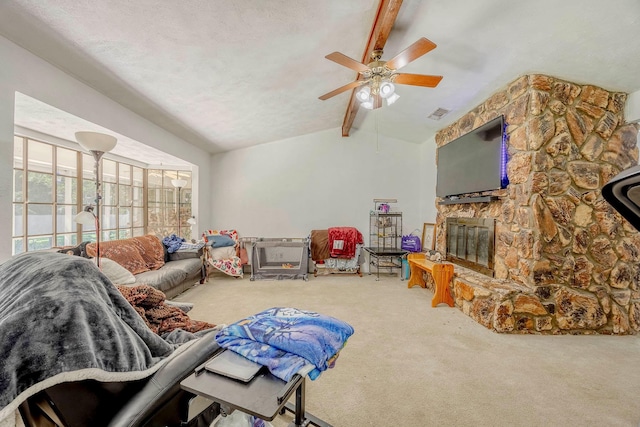 living room with ceiling fan, a fireplace, carpet, and lofted ceiling with beams