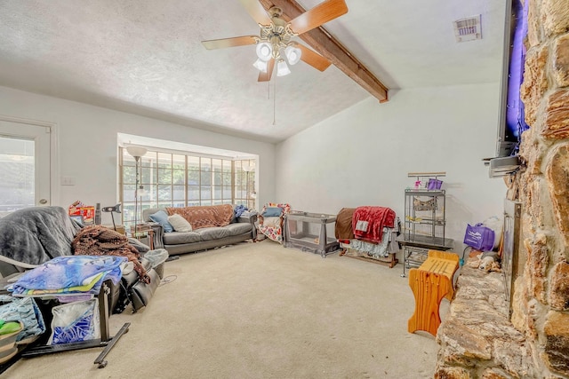 living room with lofted ceiling with beams, ceiling fan, plenty of natural light, and carpet floors