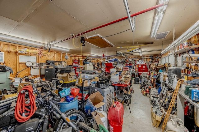 garage featuring a workshop area and wood walls