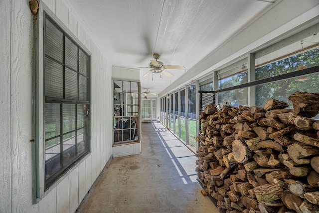 unfurnished sunroom with ceiling fan