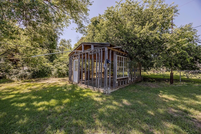 view of outbuilding with a yard