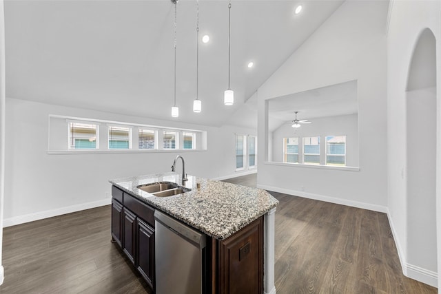 kitchen featuring sink, dishwasher, a kitchen island with sink, light stone counters, and dark brown cabinetry