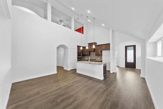 living room with sink, high vaulted ceiling, and dark hardwood / wood-style floors