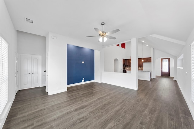 unfurnished living room with ceiling fan, dark hardwood / wood-style floors, and high vaulted ceiling