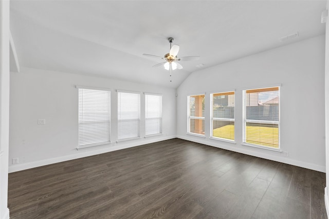 unfurnished room featuring dark hardwood / wood-style flooring, vaulted ceiling, a healthy amount of sunlight, and ceiling fan