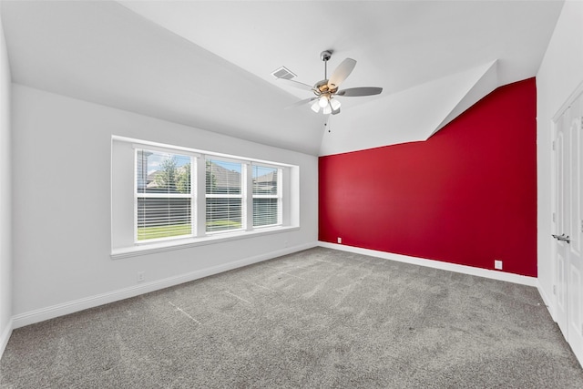 carpeted spare room with vaulted ceiling and ceiling fan