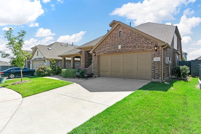 view of front of home with a garage and a front lawn