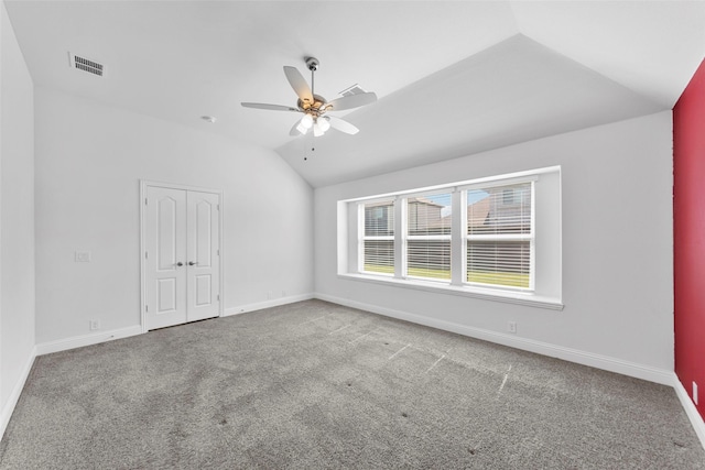 interior space featuring vaulted ceiling, ceiling fan, and carpet flooring