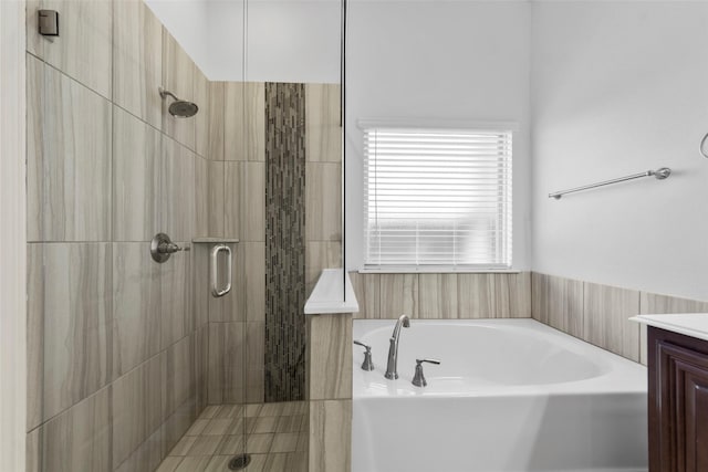 bathroom featuring vanity and shower with separate bathtub