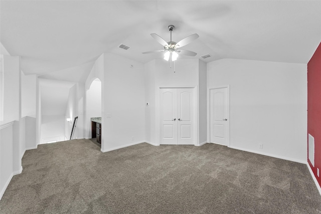 bonus room with lofted ceiling, ceiling fan, and dark colored carpet