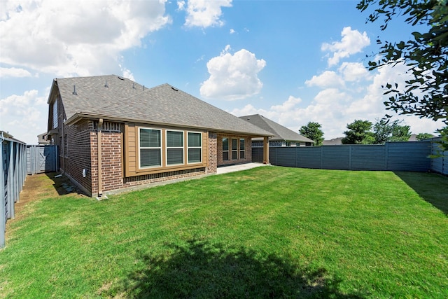 rear view of property featuring a yard