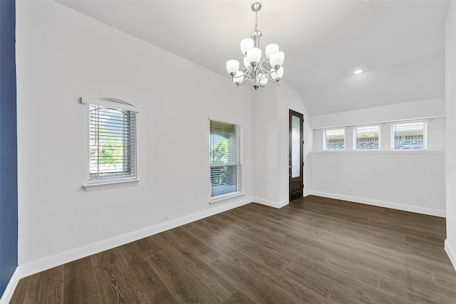 unfurnished room with lofted ceiling, dark hardwood / wood-style floors, and a notable chandelier