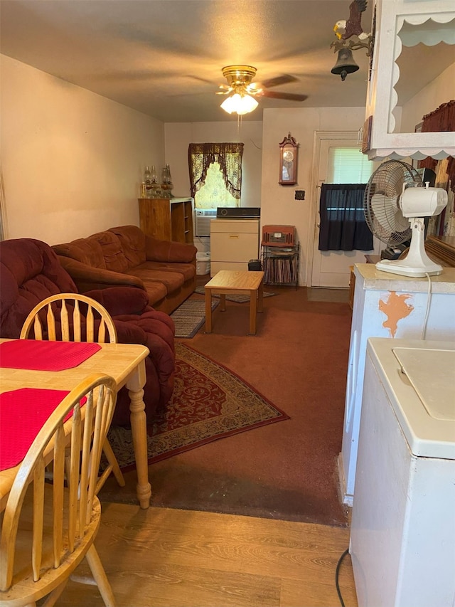 living room featuring ceiling fan, hardwood / wood-style floors, and washer / dryer