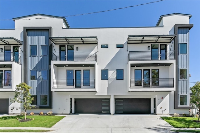 view of front of house with a front lawn, a balcony, and a garage