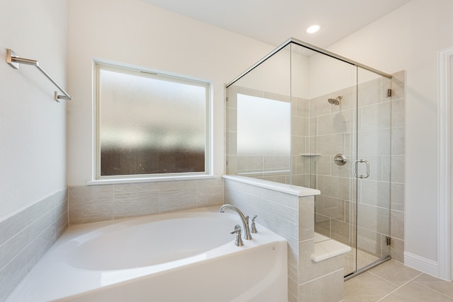 bathroom featuring plus walk in shower and tile patterned flooring