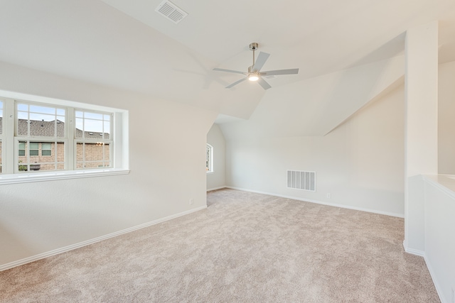 bonus room featuring ceiling fan, light colored carpet, and lofted ceiling