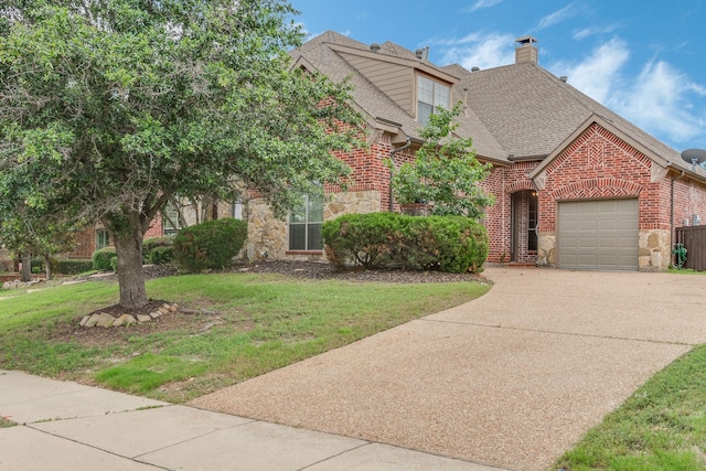 view of front of property with a garage and a front lawn