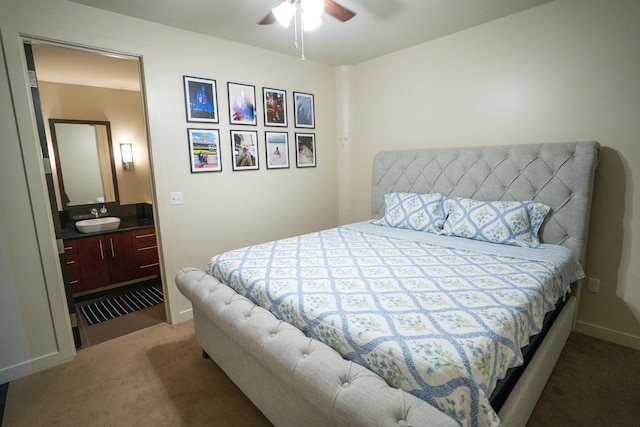 carpeted bedroom with ceiling fan and sink