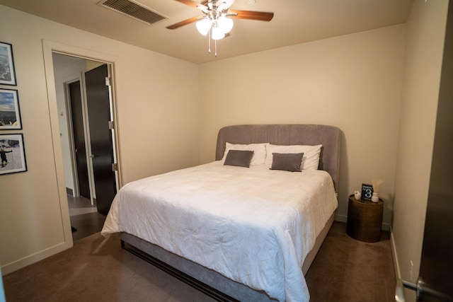 bedroom with ceiling fan and dark carpet