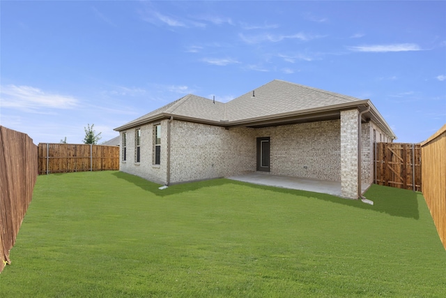 back of house featuring a patio and a yard