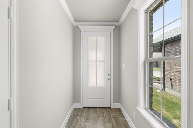 entryway with ornamental molding and light hardwood / wood-style floors