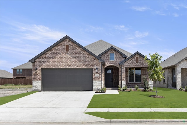 view of front of house with a front lawn and a garage