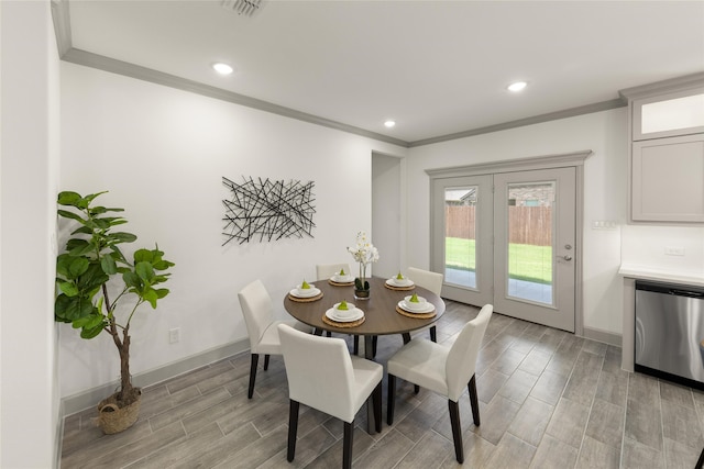 dining area with french doors, light wood-type flooring, and ornamental molding