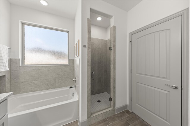 bathroom featuring tile patterned flooring, vanity, and independent shower and bath