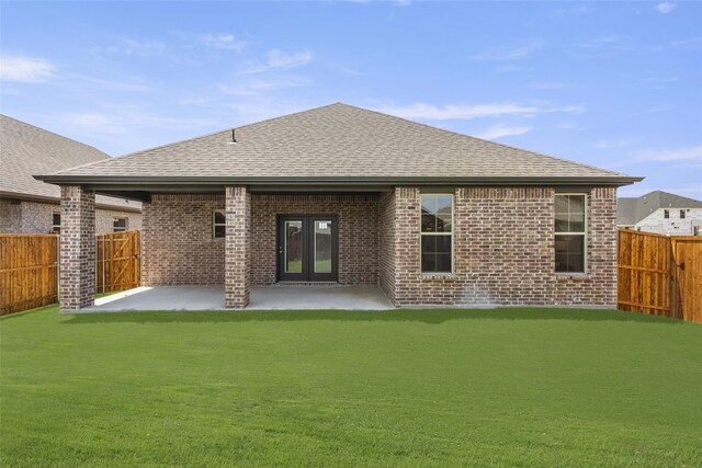 back of house featuring french doors, a patio, and a yard