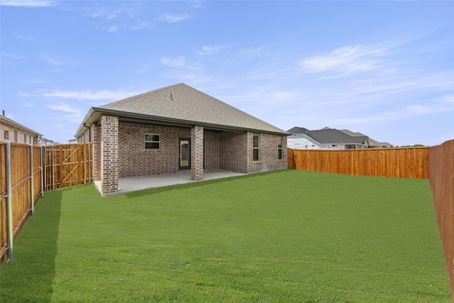 back of property featuring a patio and a yard