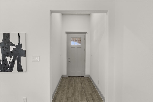 doorway with hardwood / wood-style flooring