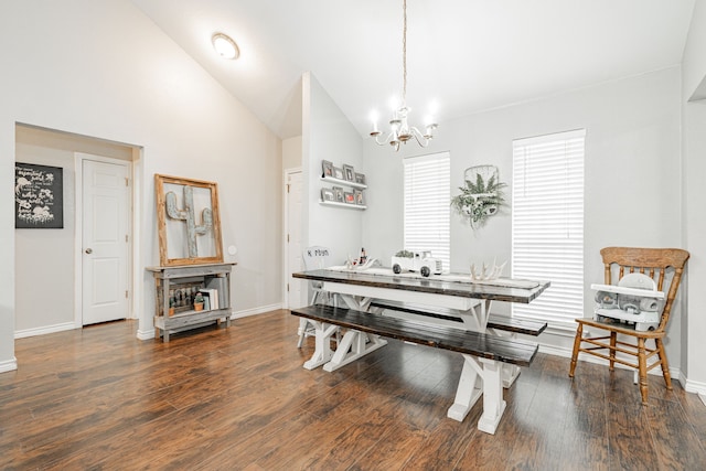 dining area featuring dark hardwood / wood-style floors, vaulted ceiling, and a notable chandelier