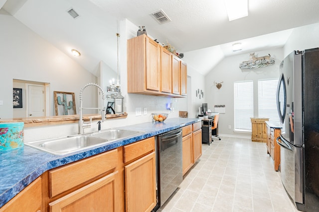 kitchen featuring light brown cabinets, sink, stainless steel appliances, and vaulted ceiling