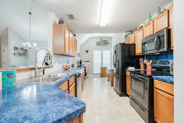 kitchen featuring sink, an inviting chandelier, pendant lighting, lofted ceiling, and appliances with stainless steel finishes