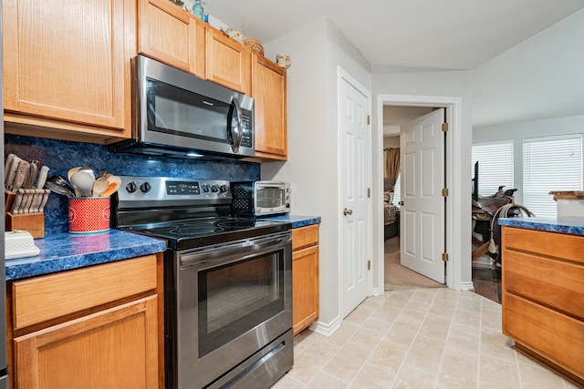 kitchen with appliances with stainless steel finishes and tasteful backsplash