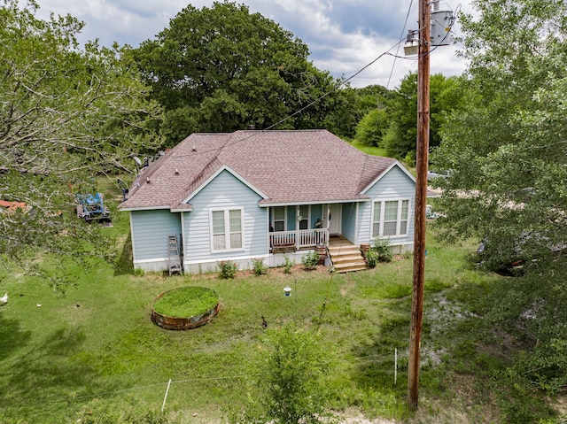 back of property with covered porch and a yard