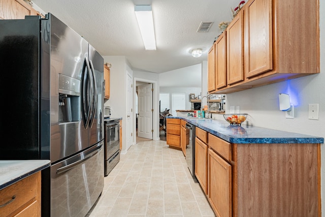 kitchen with sink, dishwasher, stainless steel fridge with ice dispenser, black / electric stove, and a textured ceiling