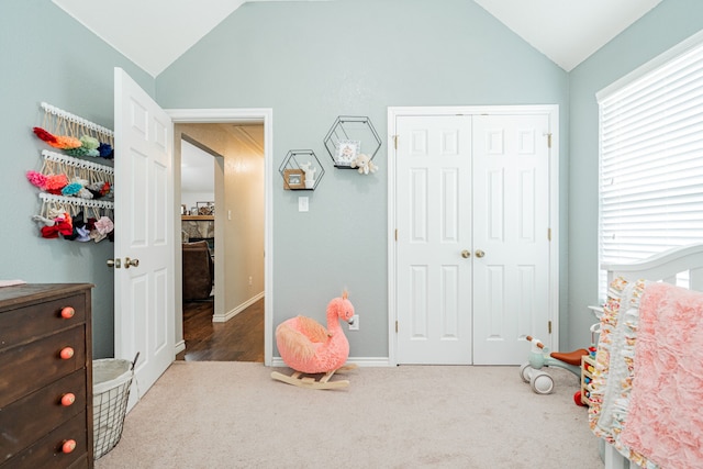 rec room featuring carpet floors, a stone fireplace, and lofted ceiling