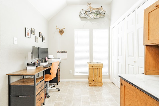 office area with vaulted ceiling