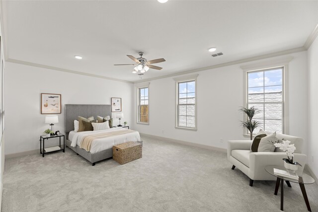 carpeted bedroom with ceiling fan, ornamental molding, and multiple windows