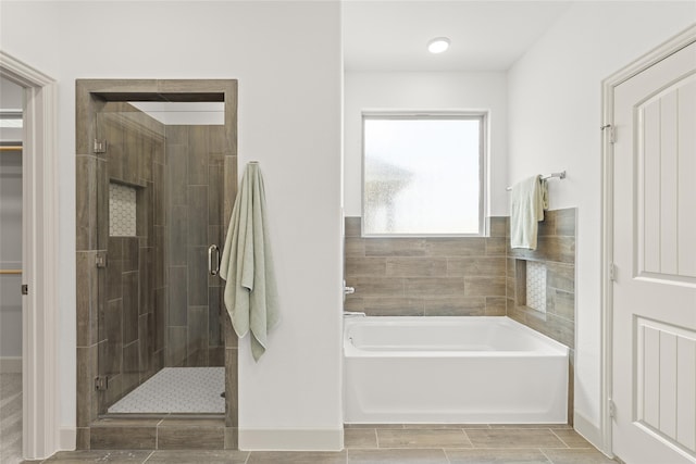 bathroom with independent shower and bath and tile patterned floors