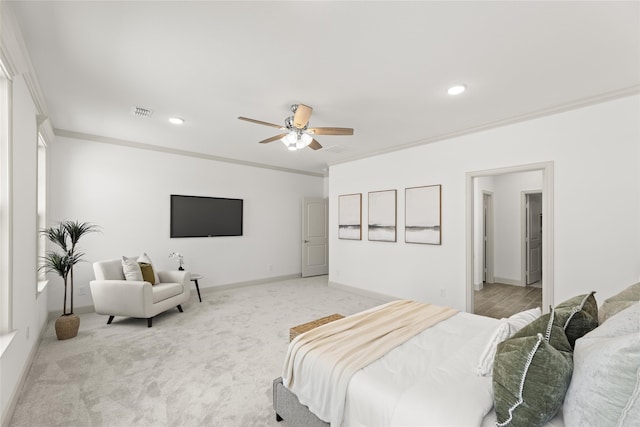 carpeted bedroom featuring crown molding and ceiling fan