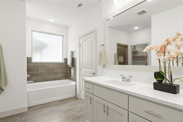 bathroom with tile patterned floors, separate shower and tub, and vanity