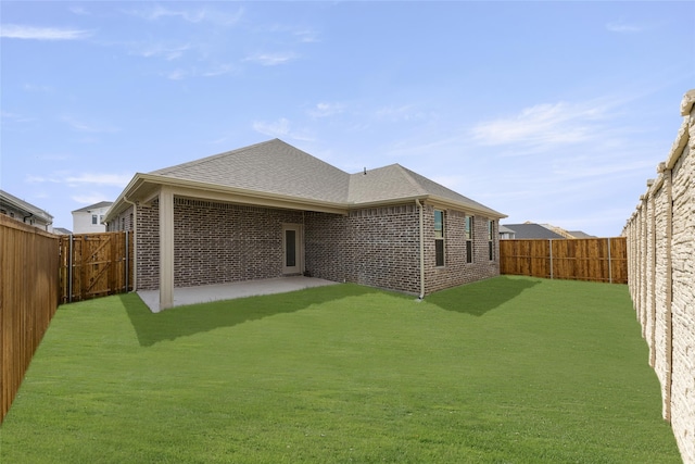 rear view of house with a yard and a patio area