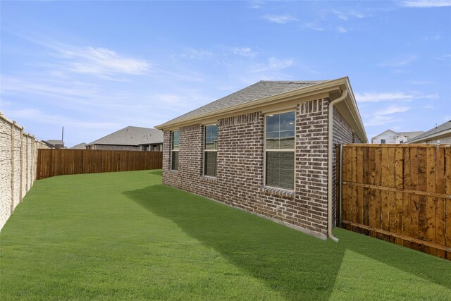 view of side of property with a yard