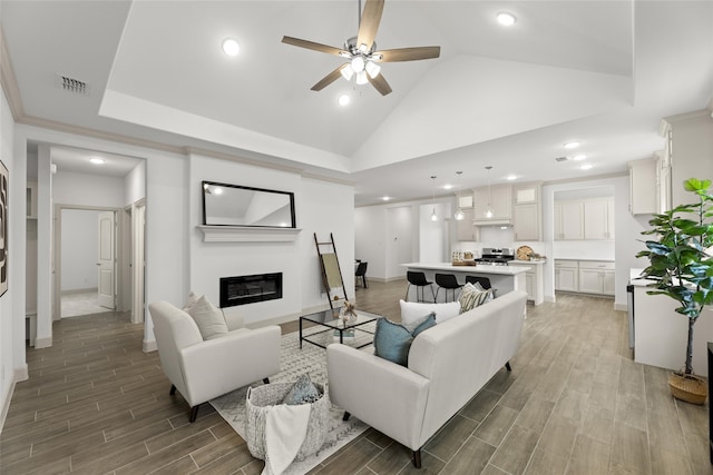 living room with high vaulted ceiling, ceiling fan, and wood-type flooring