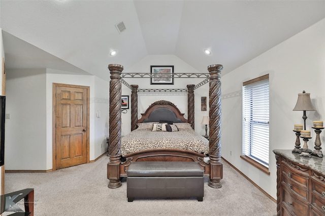 bedroom featuring light colored carpet and lofted ceiling