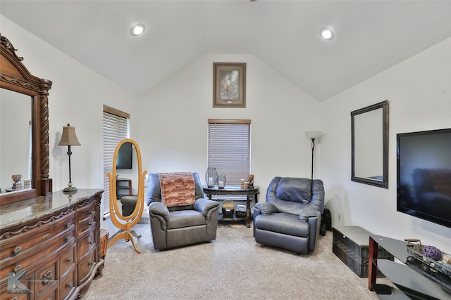 carpeted living room with vaulted ceiling