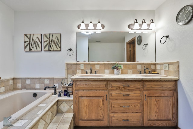 bathroom with a relaxing tiled bath, dual sinks, and large vanity