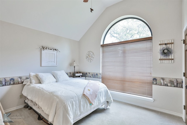 carpeted bedroom featuring ceiling fan and lofted ceiling